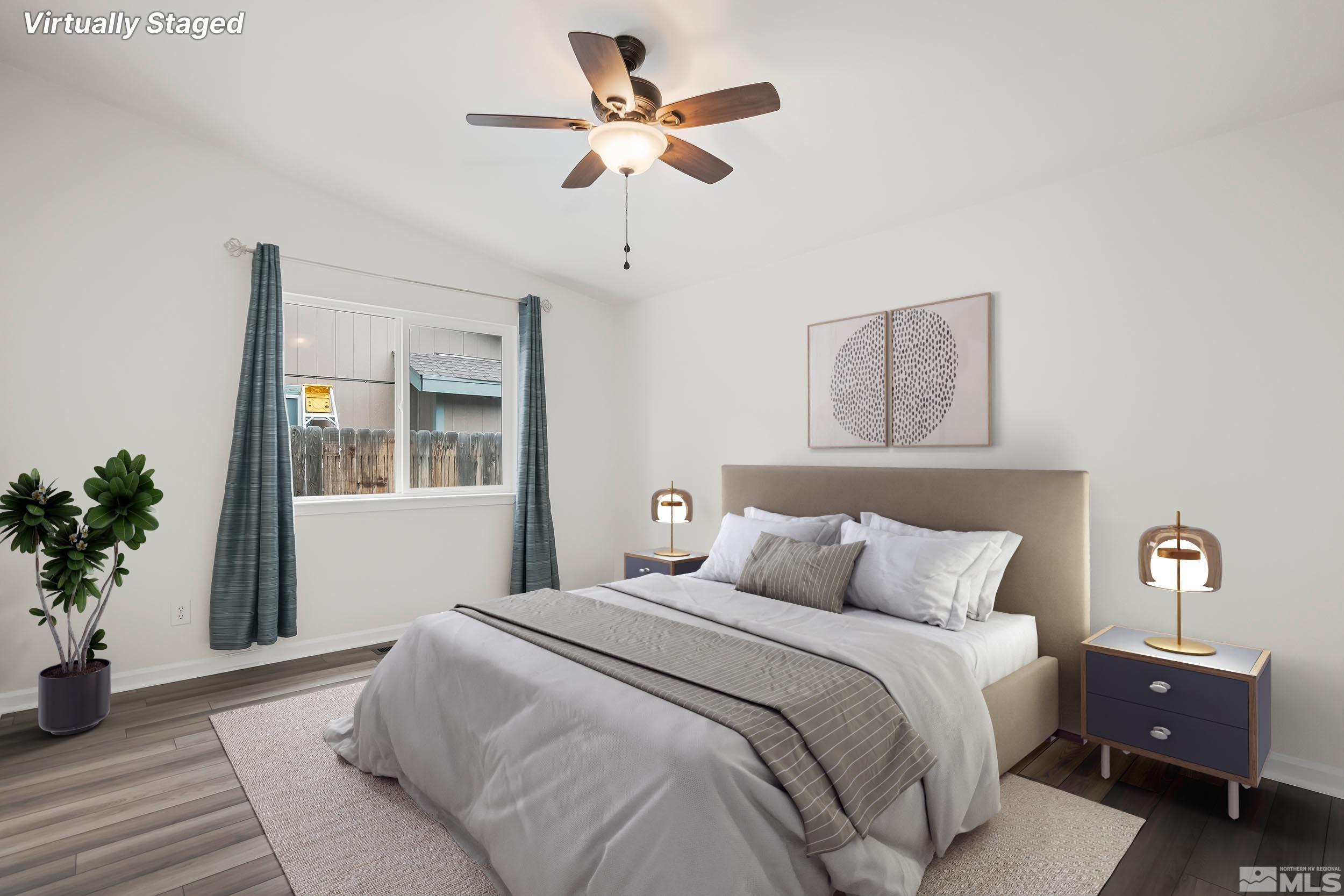 150 Rosecrest Drive Fernley, NV 89408 - Photo 13 of 28 a bedroom with a bed and a chandelier