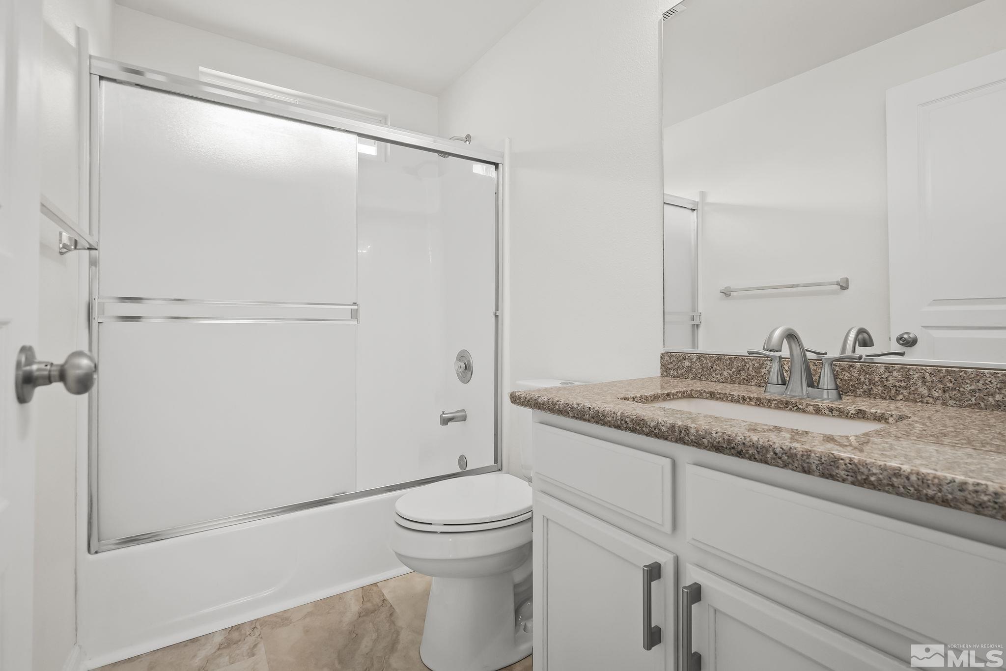 150 Rosecrest Drive Fernley, NV 89408 - Photo 22 of 28 a bathroom with a granite countertop sink toilet and shower