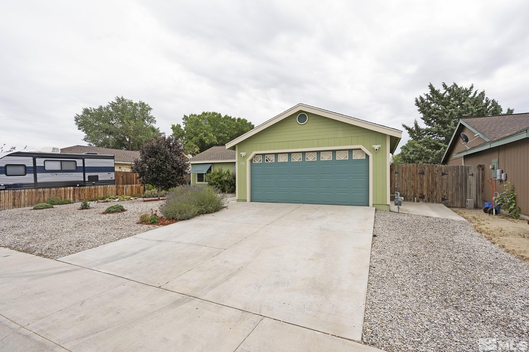150 Rosecrest Drive Fernley, NV 89408 - Photo 28 of 28 a front view of a house with a yard and garage