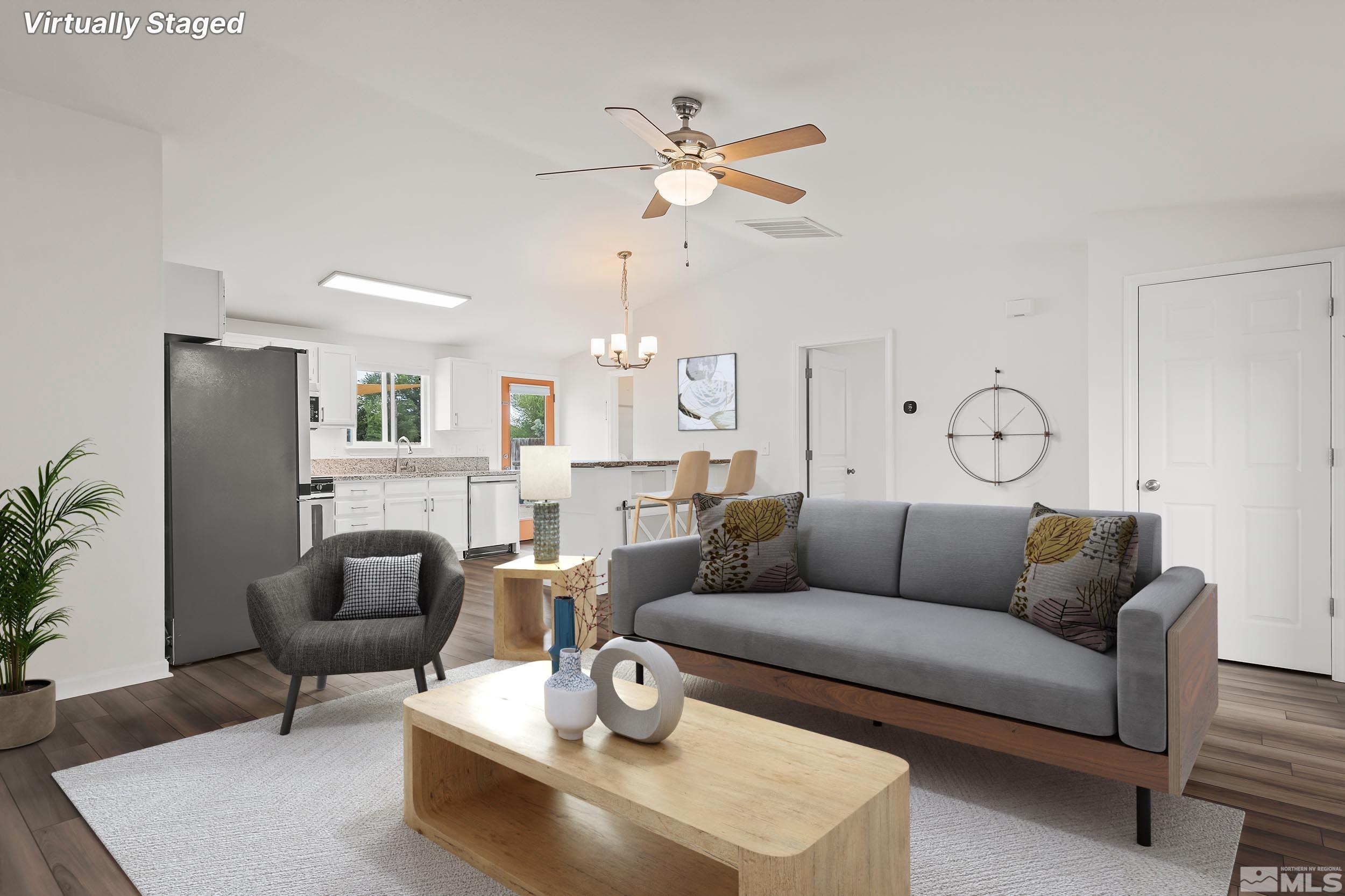 150 Rosecrest Drive Fernley, NV 89408 - Photo 3 of 28 a living room with furniture kitchen view and a chandelier