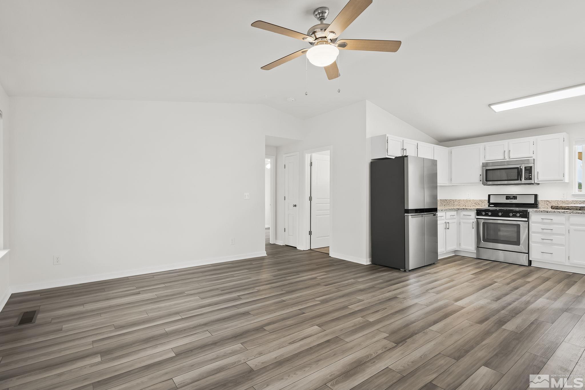 150 Rosecrest Drive Fernley, NV 89408 - Photo 5 of 28 a view of kitchen with stainless steel appliances wooden floor and a window