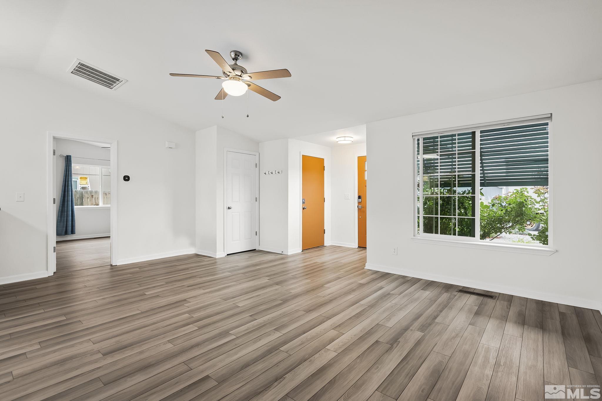 150 Rosecrest Drive Fernley, NV 89408 - Photo 7 of 28 a view of an empty room with wooden floor and a window