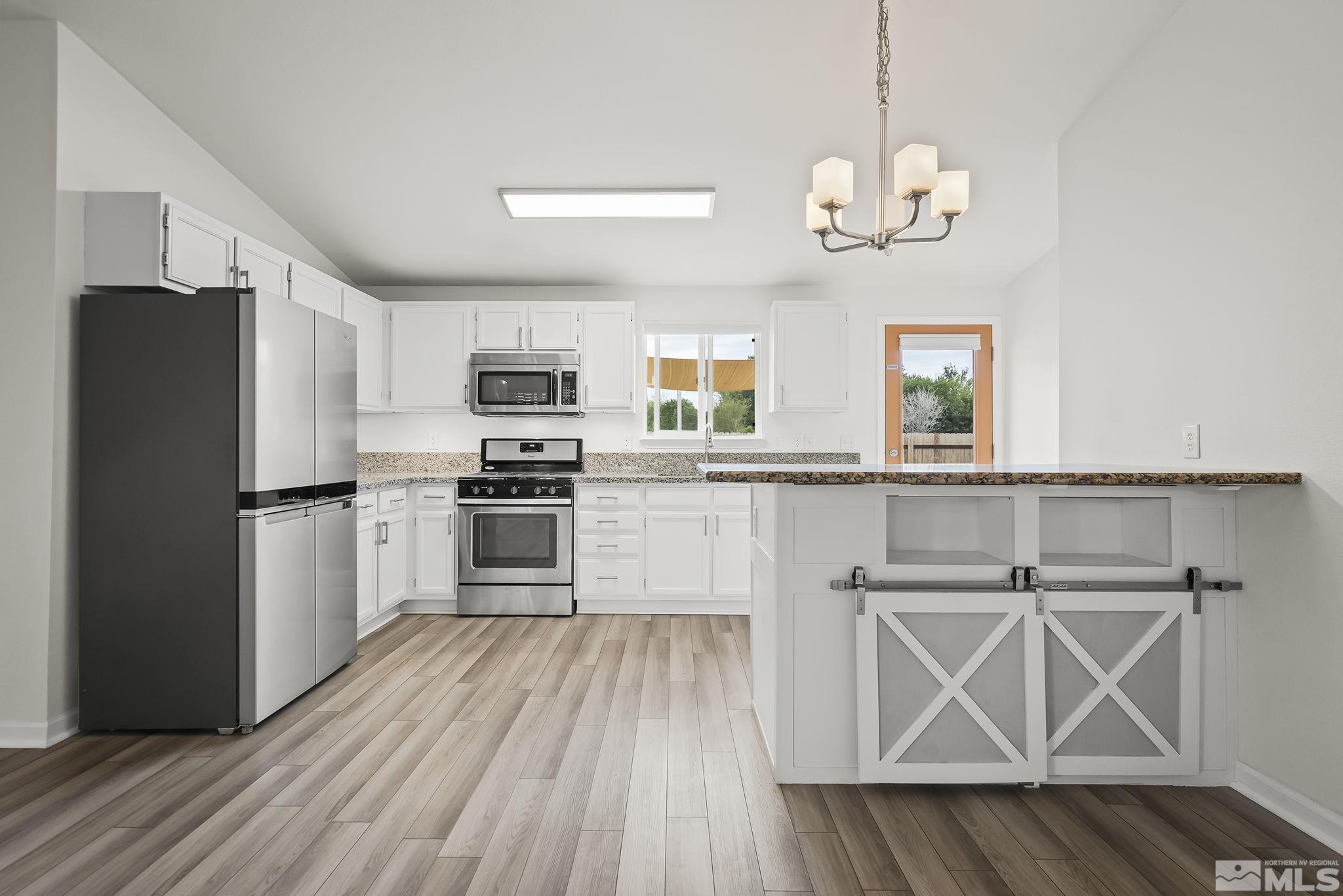 150 Rosecrest Drive Fernley, NV 89408 - Photo 8 of 28 a kitchen with a refrigerator and a stove
