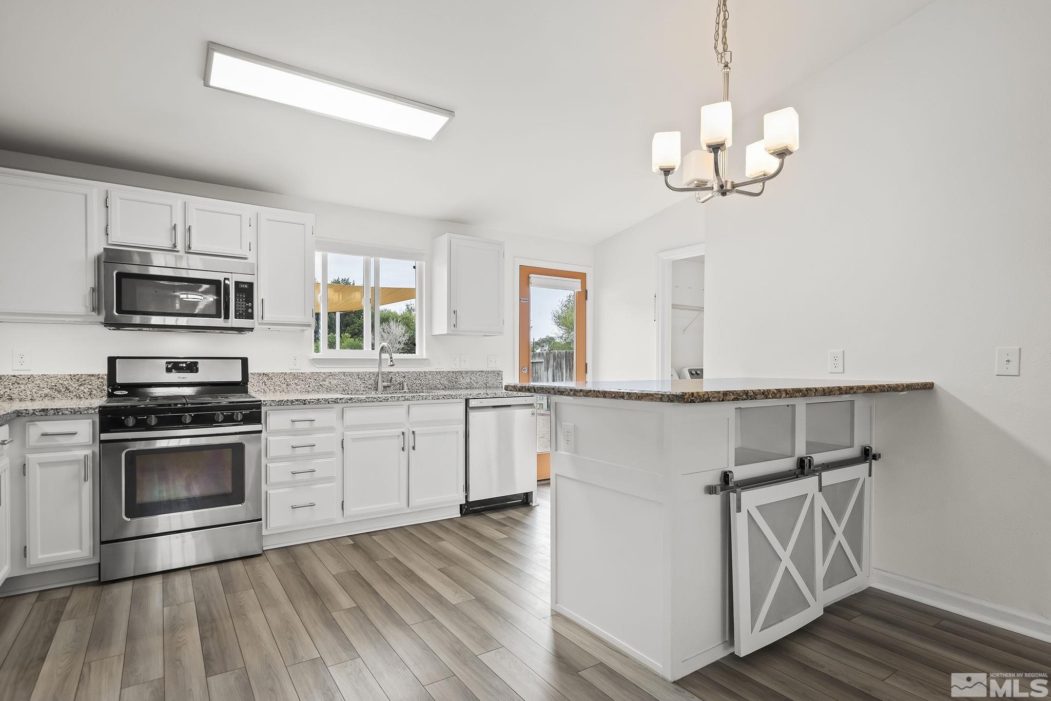 150 Rosecrest Drive Fernley, NV 89408 - Photo 9 of 28 a kitchen with a refrigerator cabinets and wooden floor