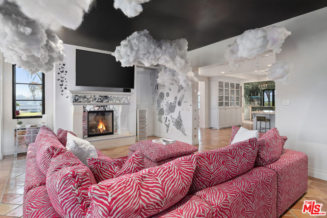 1650 Luse Tank Road Topanga, CA 90290 - Photo 14 of 50 a living room with furniture a flat screen tv and a fireplace