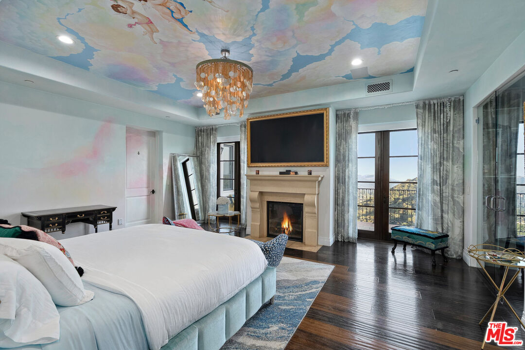 1650 Luse Tank Road Topanga, CA 90290 - Photo 23 of 50 a spacious bedroom with a bed and a flat screen tv