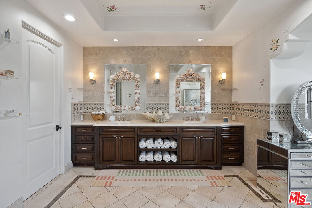 1650 Luse Tank Road Topanga, CA 90290 - Photo 28 of 50 a spacious bathroom with a granite countertop double vanity and a mirror