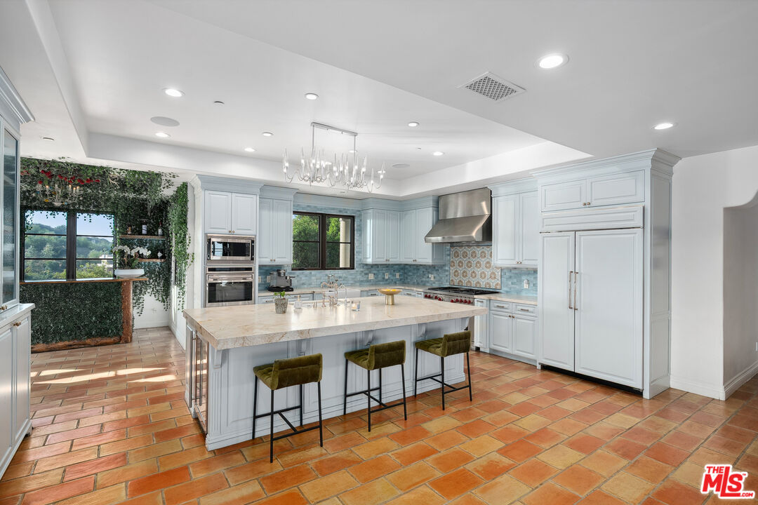 1650 Luse Tank Road Topanga, CA 90290 - Photo 10 of 50 a large kitchen with a table and chairs in it