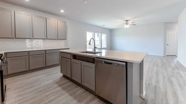 a kitchen with sink and cabinets