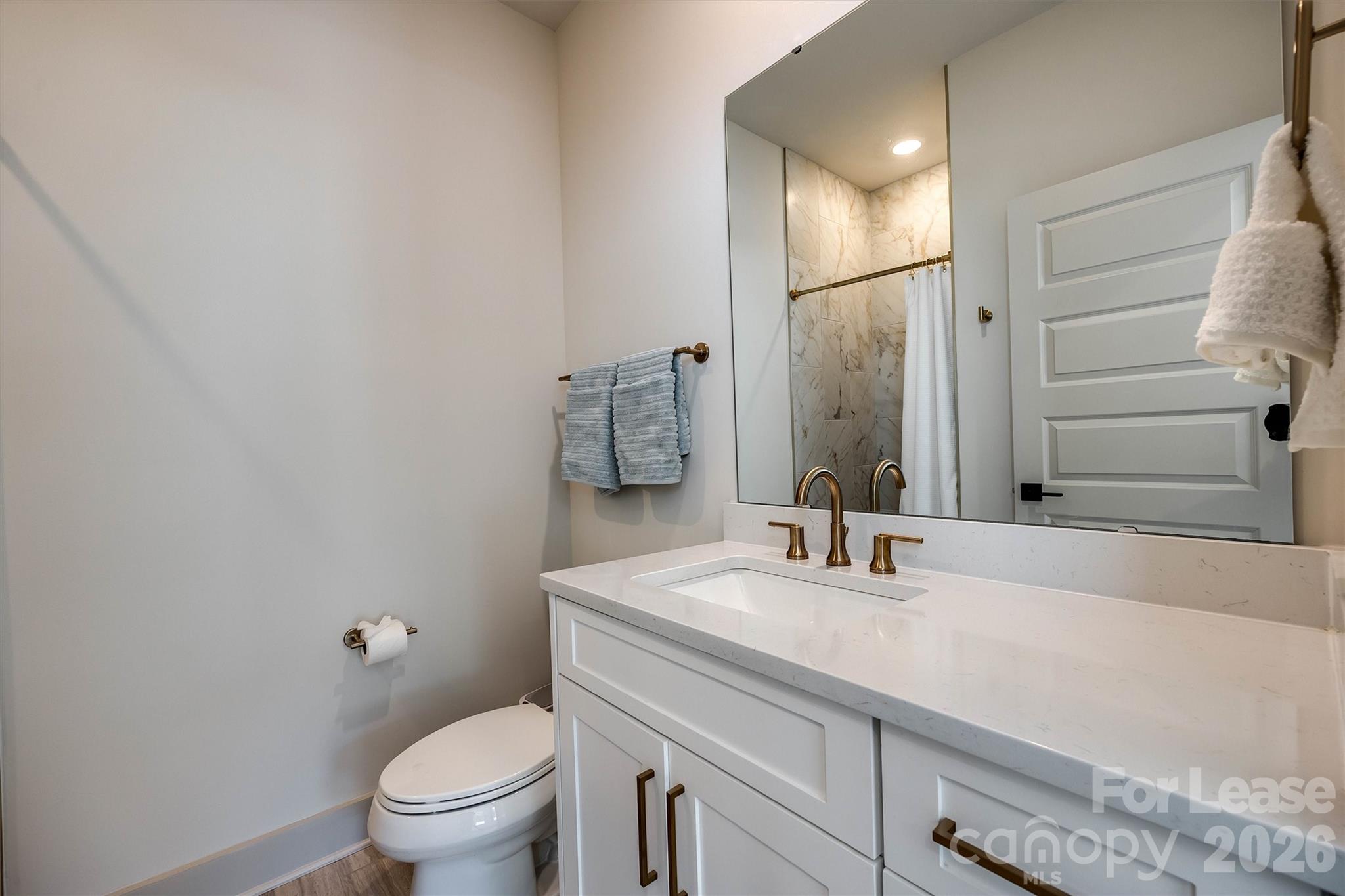 2319 Wesley Village Road Charlotte, NC 28208 - Photo 9 of 44 a bathroom with a sink toilet and shower