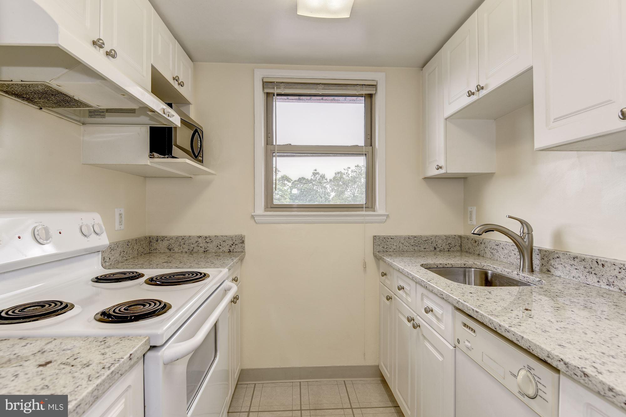 4635 20th Road North, Unit 11 Arlington, VA 22207 - Photo 9 of 22 a kitchen with a sink stove top oven and cabinets