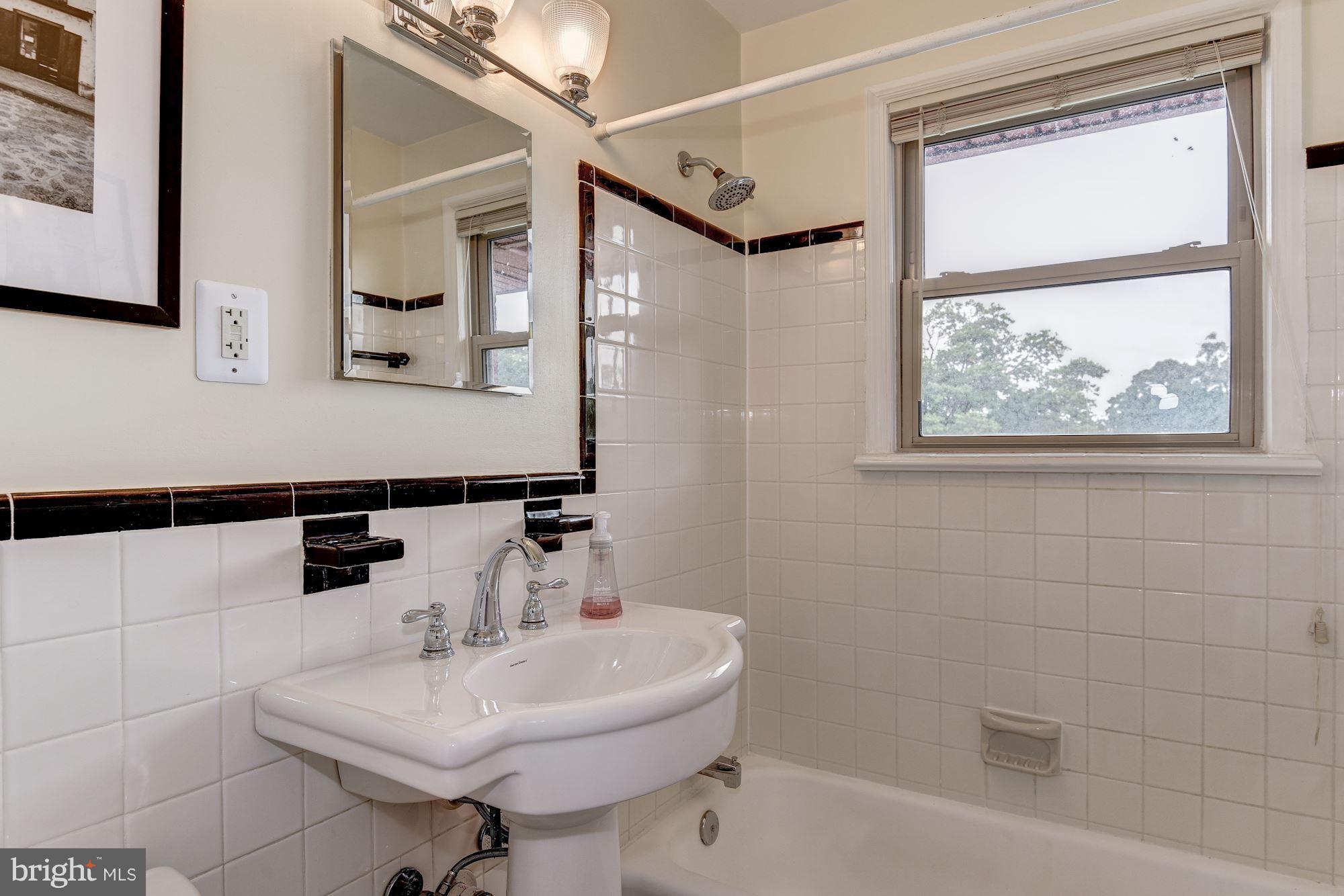 4635 20th Road North, Unit 11 Arlington, VA 22207 - Photo 10 of 22 a bathroom with a sink a mirror and a shower