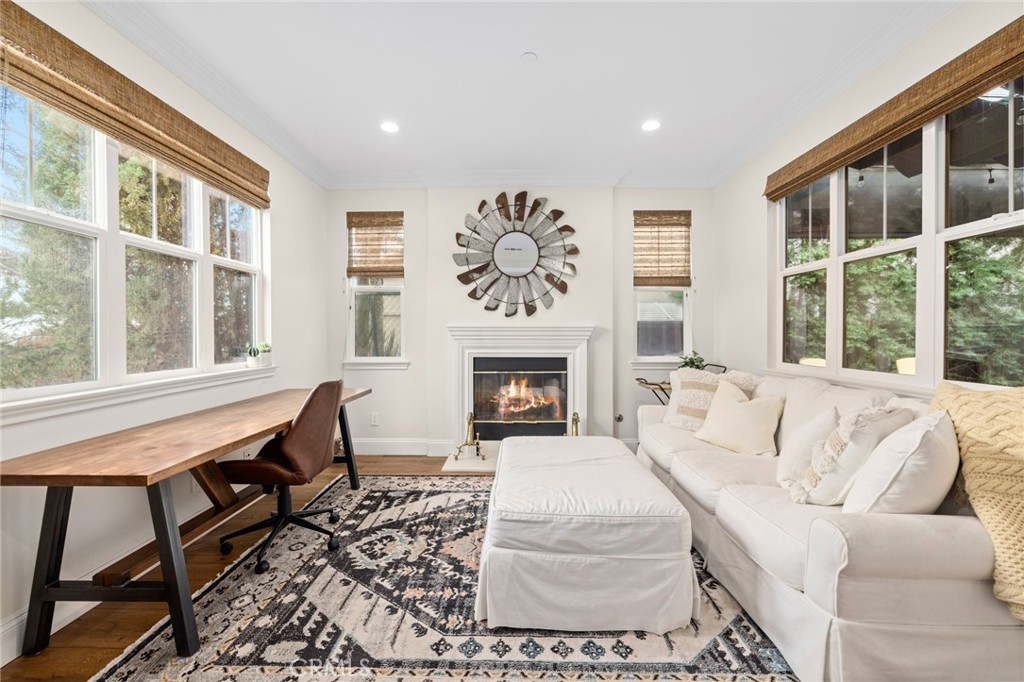 18 Bower Lane Ladera Ranch, CA 92694 - Photo 13 of 31 a living room with furniture a large window and a fireplace