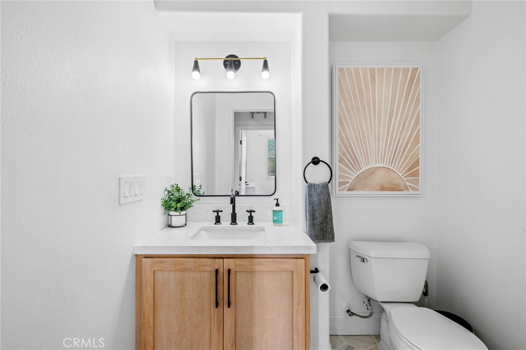 18 Bower Lane Ladera Ranch, CA 92694 - Photo 15 of 31 a bathroom with a toilet sink and mirror