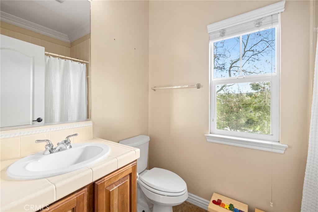 18 Bower Lane Ladera Ranch, CA 92694 - Photo 16 of 31 a bathroom with a granite countertop sink mirror vanity and toilet