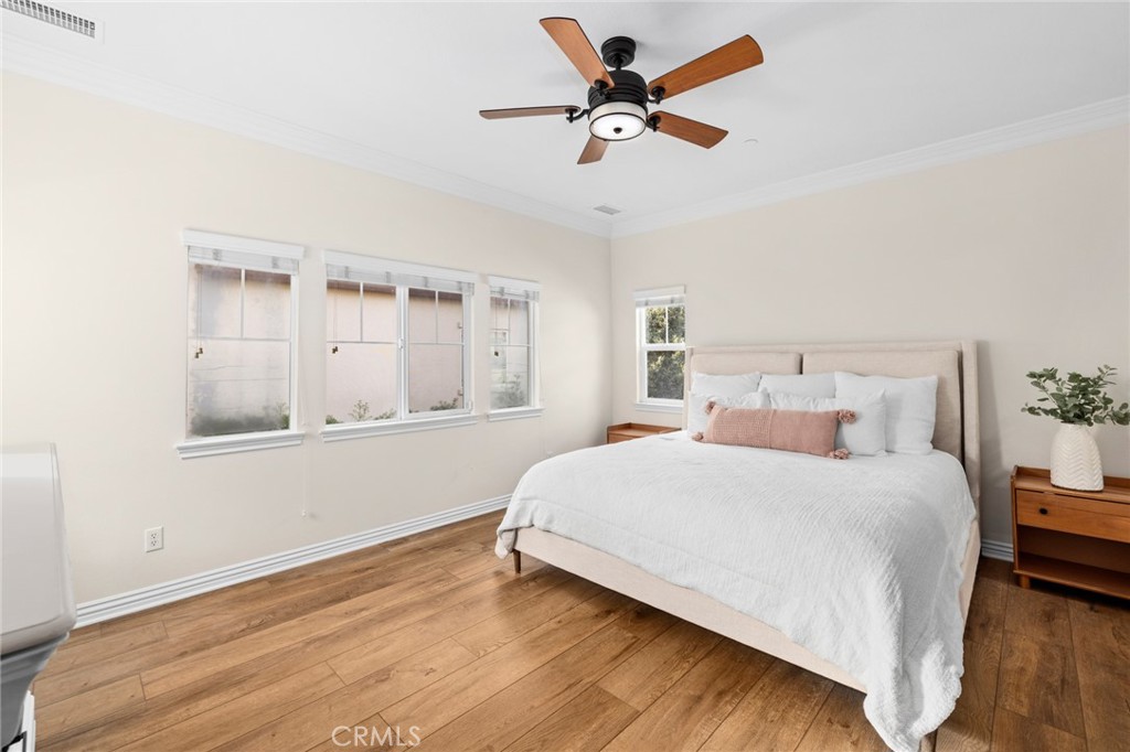 18 Bower Lane Ladera Ranch, CA 92694 - Photo 20 of 31 a bedroom with a large bed and a chandelier