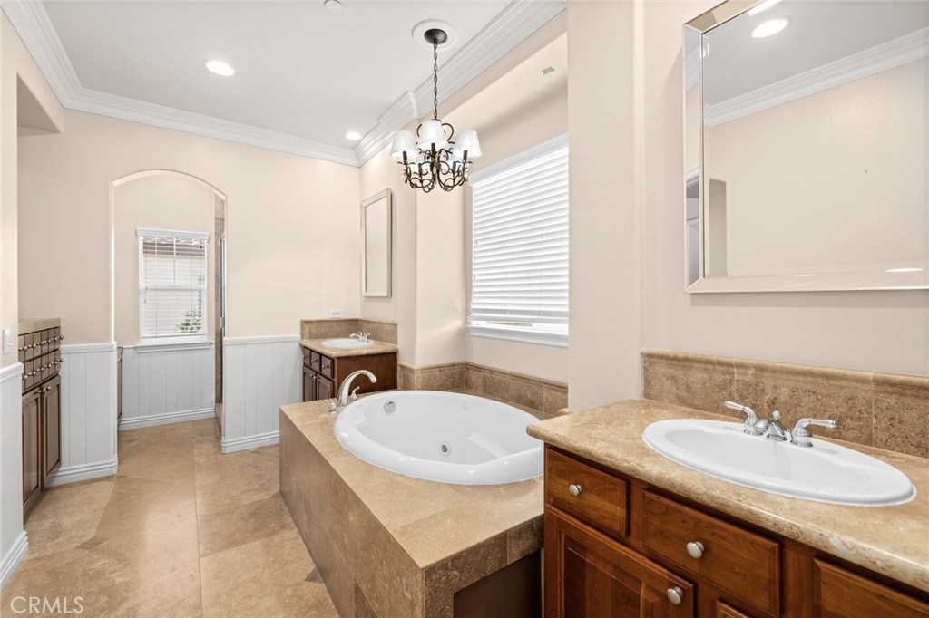 18 Bower Lane Ladera Ranch, CA 92694 - Photo 22 of 31 a bathroom with a granite countertop sink a mirror and a bathtub