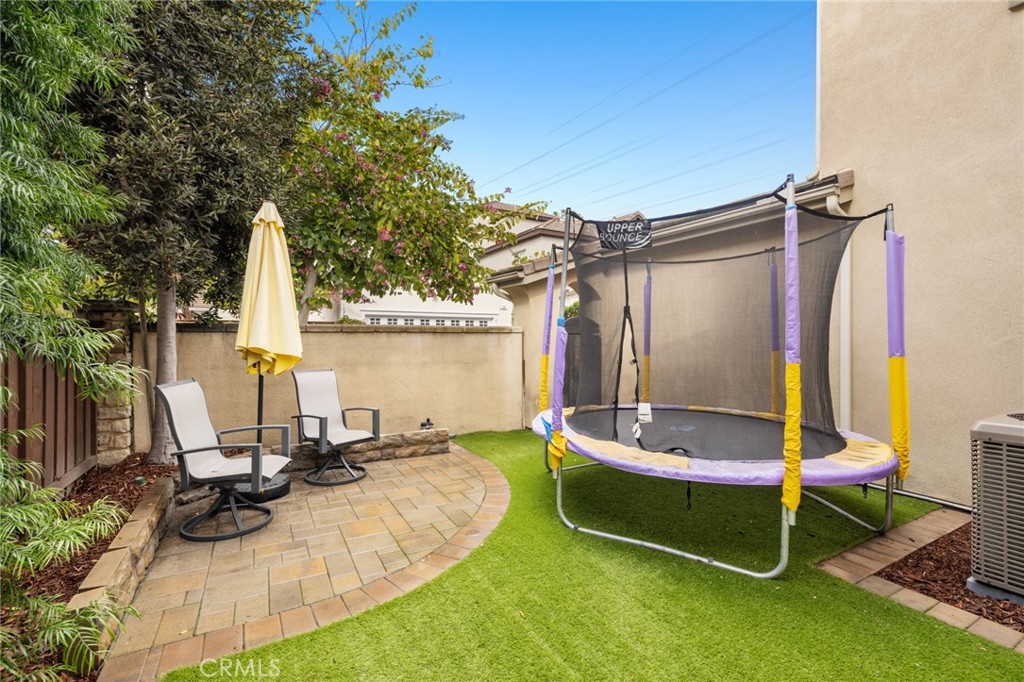 18 Bower Lane Ladera Ranch, CA 92694 - Photo 27 of 31 a small garden with a bench and some trees