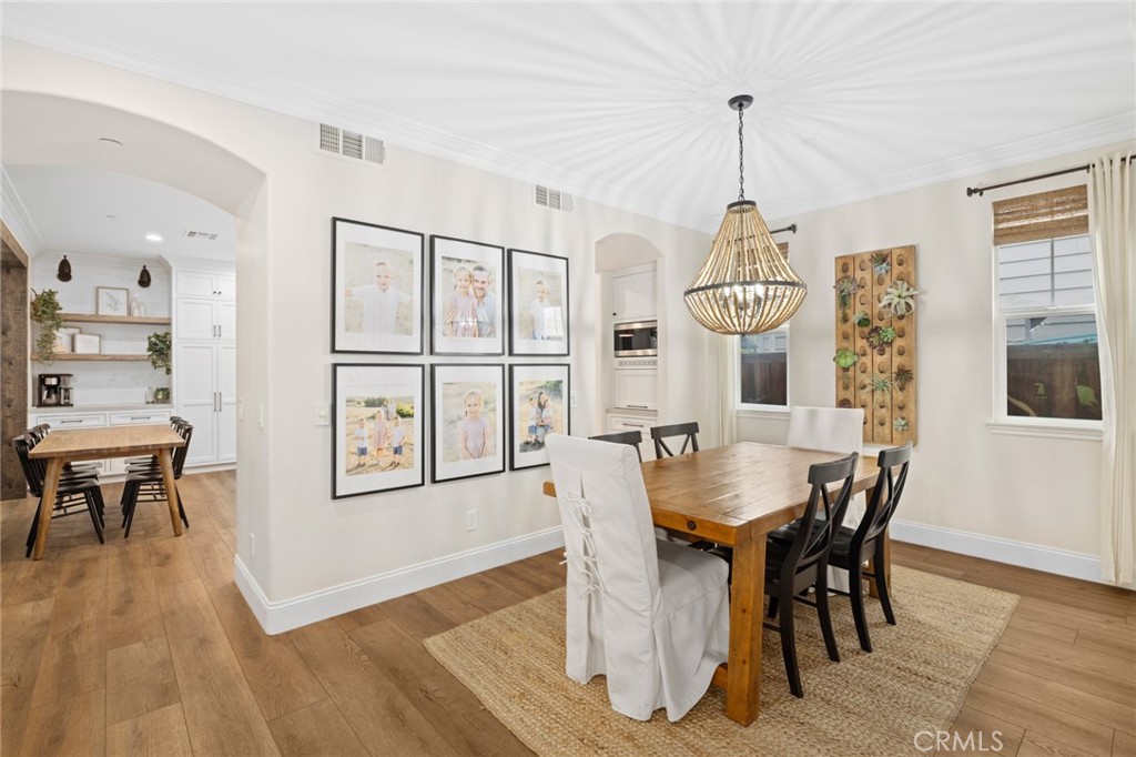 18 Bower Lane Ladera Ranch, CA 92694 - Photo 7 of 31 a view of a dining room with furniture window and wooden floor