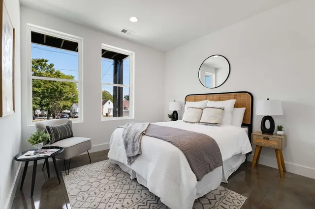 a bedroom with a large bed and a couch