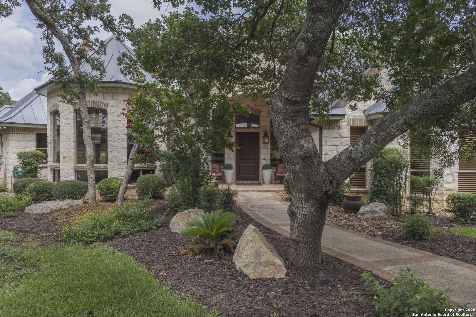 241 Seewald Road Boerne, TX 78006 - Photo 4 of 48 a view of a patio with couches plants and large trees
