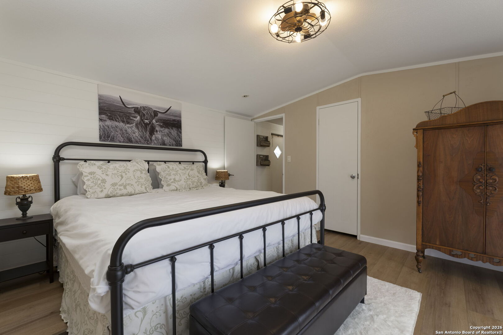 241 Seewald Road Boerne, TX 78006 - Photo 42 of 48 a bedroom with a bed and wooden floor