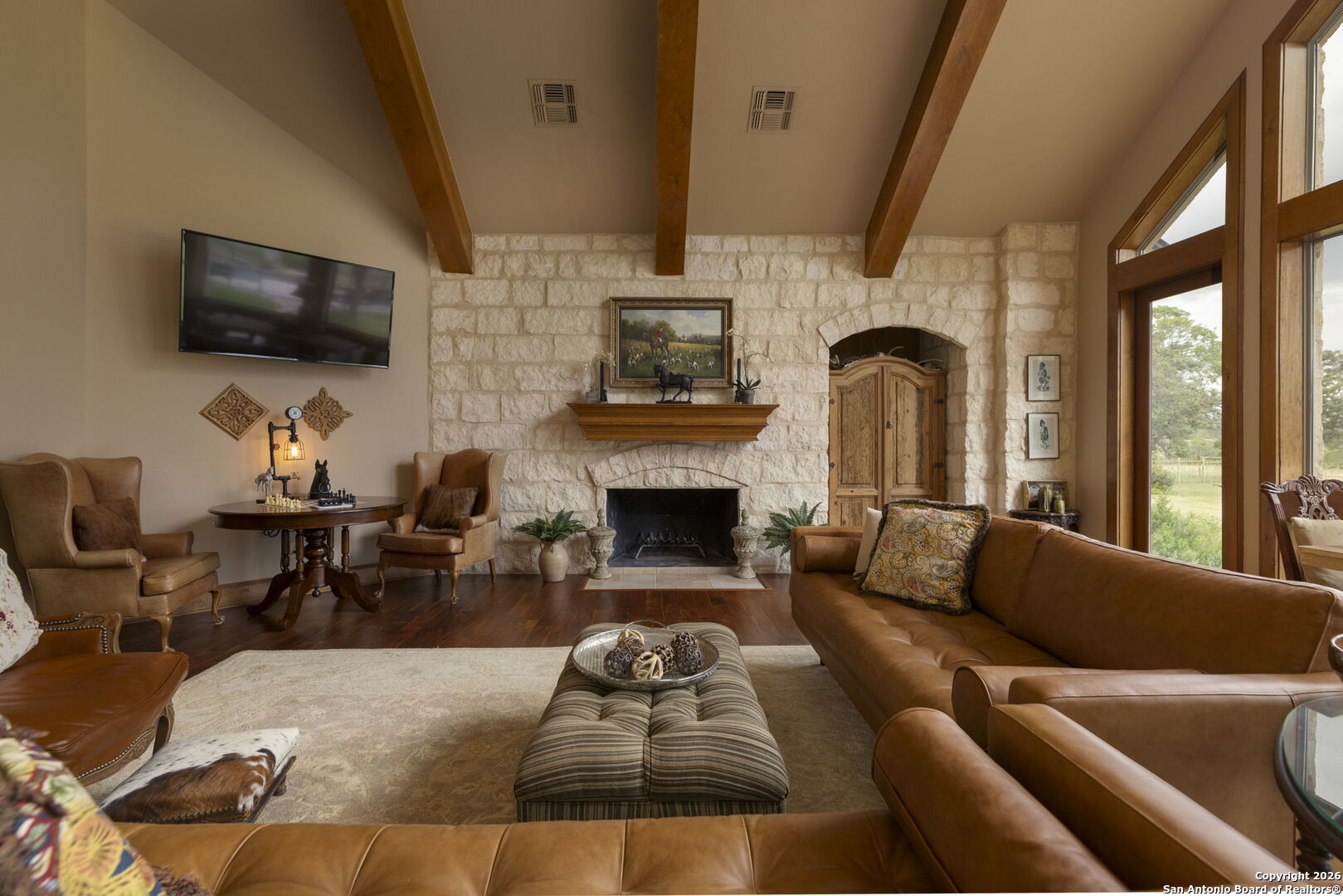 241 Seewald Road Boerne, TX 78006 - Photo 6 of 48 a living room with furniture a flat screen tv and a fireplace
