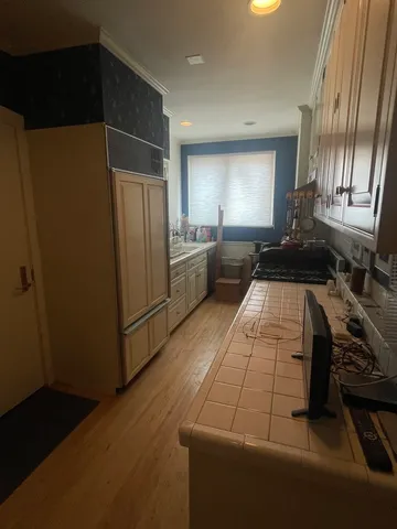 a kitchen with refrigerator and window