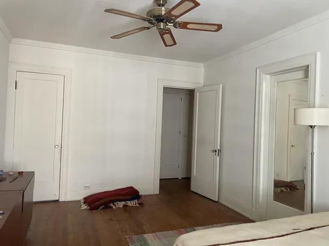 a view of room with hardwood floor and hallway