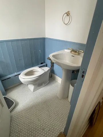 a bathroom with a sink a toilet and a mirror