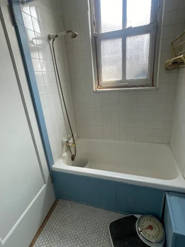 a bathroom with a tub and a shower