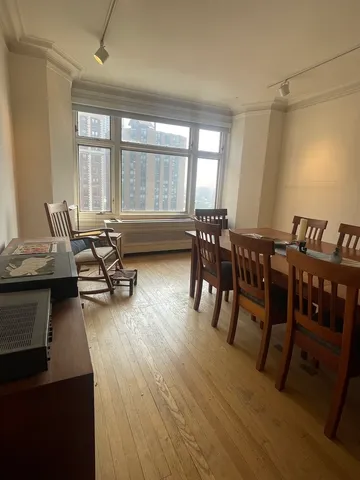 a living room with furniture a wooden floor and a window