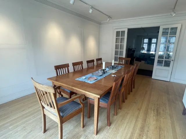 a view of a dining room with furniture and wooden floor