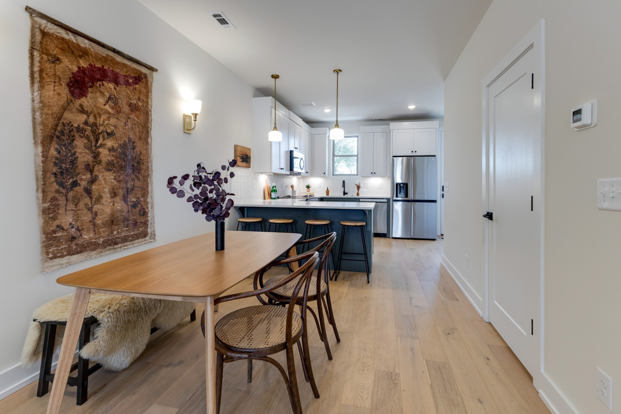 145 Whitsett Road, Unit 6 Nashville, TN 37210 - Photo 12 of 33 a kitchen with stainless steel appliances a dining table chairs and wooden floor