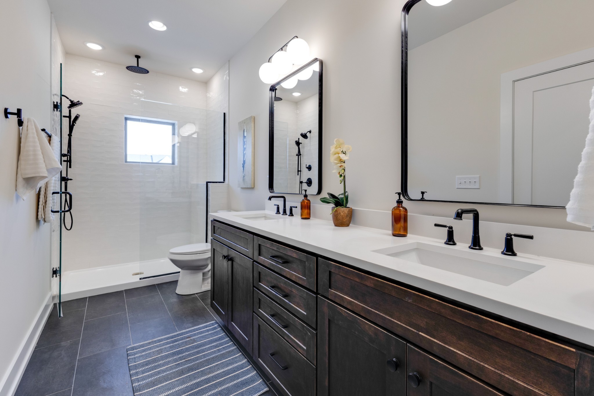 145 Whitsett Road, Unit 6 Nashville, TN 37210 - Photo 24 of 33 a bathroom with a double vanity sink a toilet and a mirror