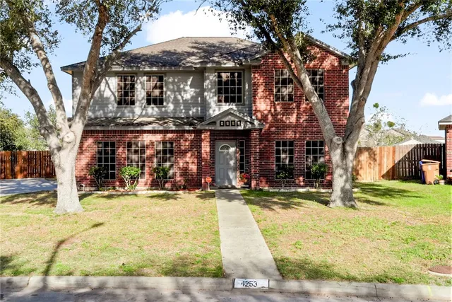 a view of a house with snow on the tree