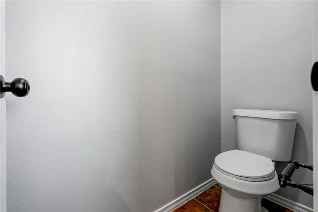 a white toilet sitting next to a shower