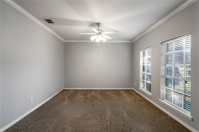 a view of a room with a ceiling fan and a large window