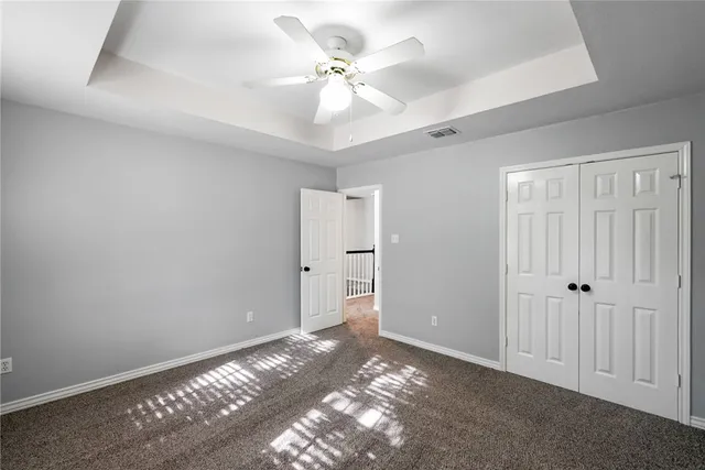 a view of an empty room with a ceiling fan