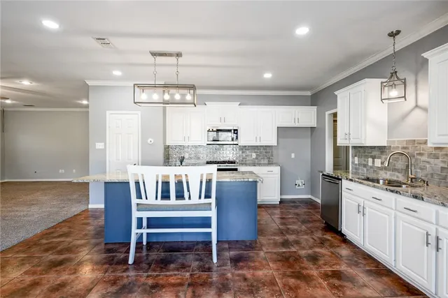 a kitchen that has a lot of cabinets in it and appliances
