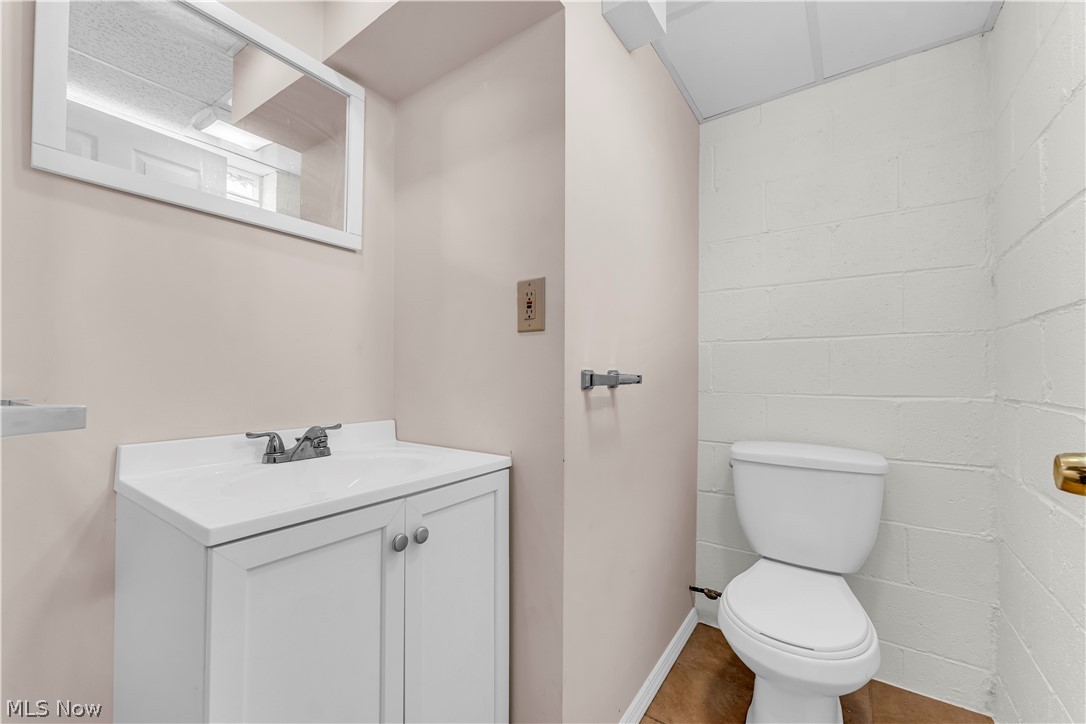 9716 Alexander Road Cleveland, OH 44125 - Photo 22 of 30 Half bathroom featuring concrete block wall and vanity