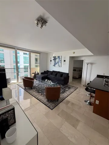 a living room with furniture window and flat screen tv