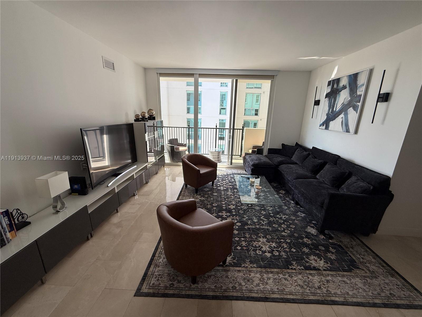 4100 Salzedo Street, Unit 811 Coral Gables, FL 33146 - Photo 13 of 28 a living room with furniture and a flat screen tv