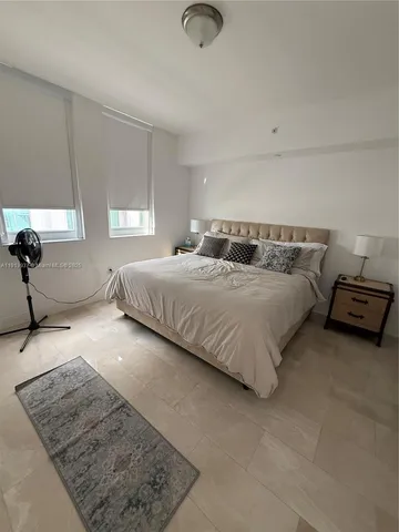 a bedroom with a bed and a couch