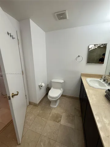 a bathroom with a sink vanity and mirror