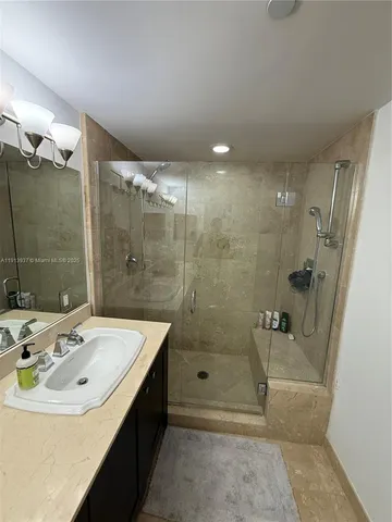 a bathroom with a sink vanity and a mirror