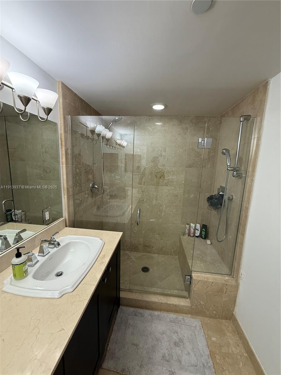 4100 Salzedo Street, Unit 811 Coral Gables, FL 33146 - Photo 21 of 28 a bathroom with a sink and mirror