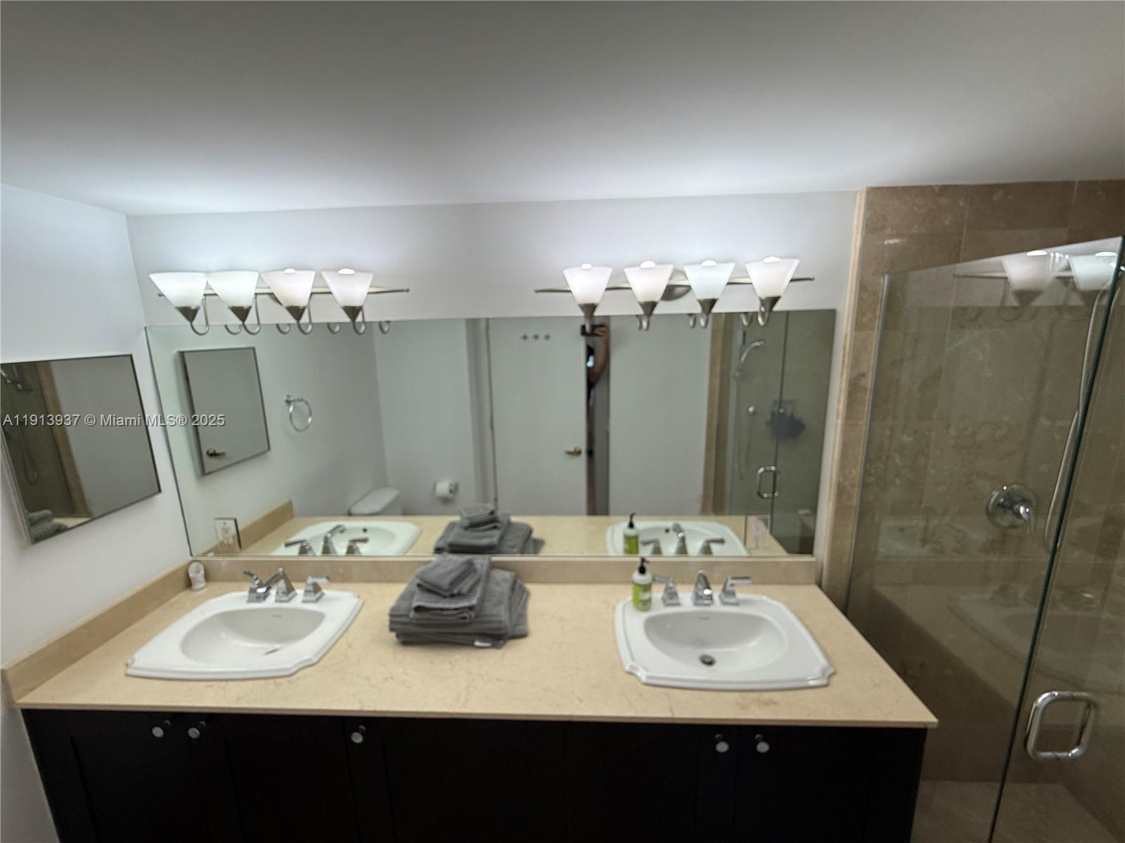 4100 Salzedo Street, Unit 811 Coral Gables, FL 33146 - Photo 22 of 28 a bathroom with a sink vanity and mirror
