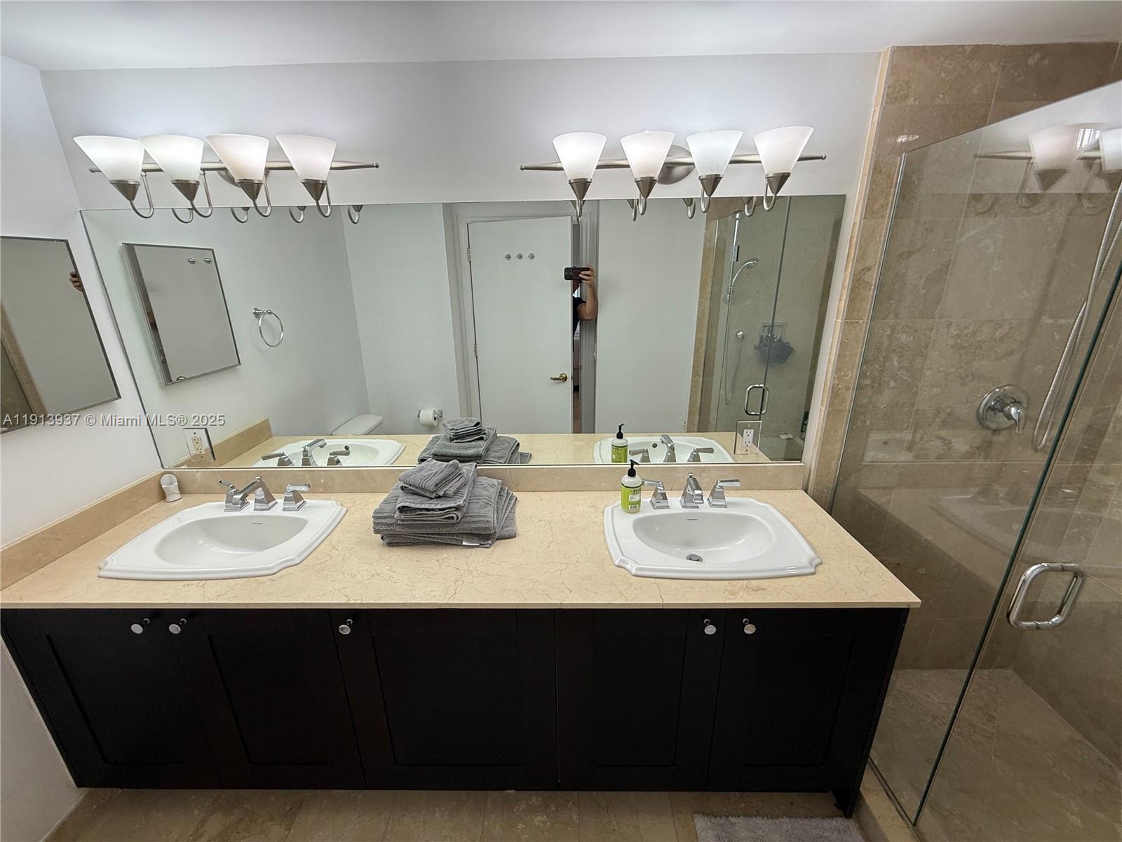 4100 Salzedo Street, Unit 811 Coral Gables, FL 33146 - Photo 23 of 28 a bathroom with a sink vanity and a mirror