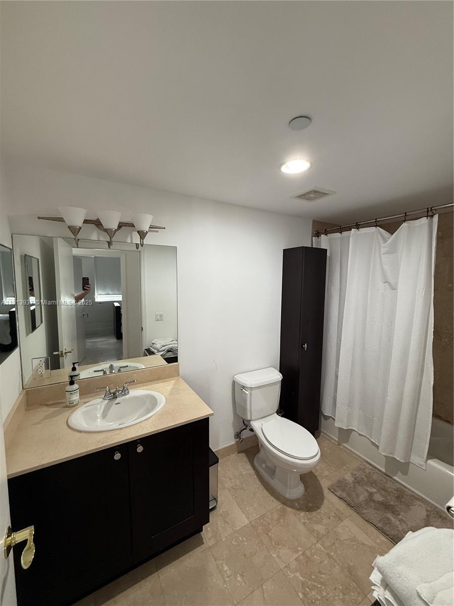 4100 Salzedo Street, Unit 811 Coral Gables, FL 33146 - Photo 26 of 28 a bathroom with a sink and a mirror